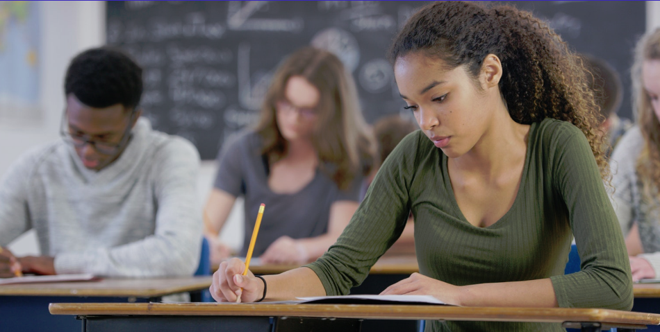 Students sitting at desk learning in classroom